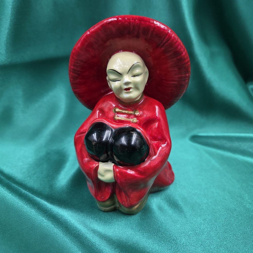 Red Ceramic Figurine with Hat